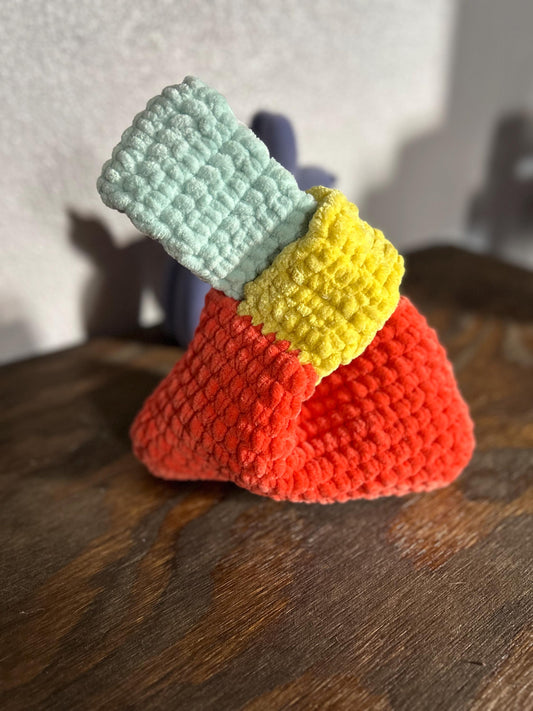 Crocheted Japanese knot purse on a wooden surface