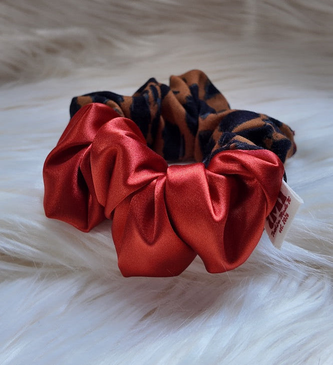 Red satin scrunchie on a fur surface