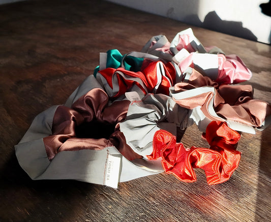 Set of colorful scrunchies on a wooden surface